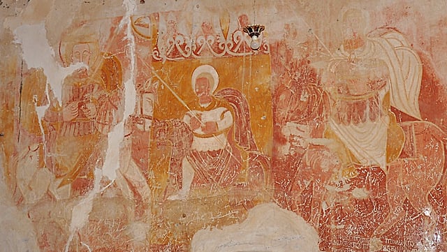 wall painting of several Saints, in yellow, red and ochre colours
